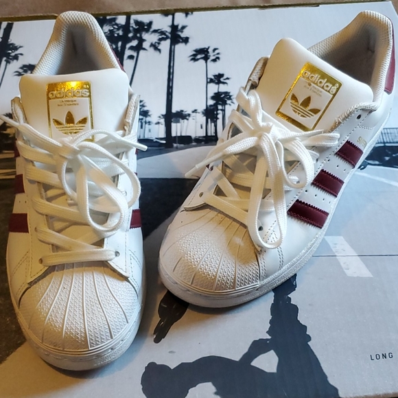 white adidas shoes with gold
